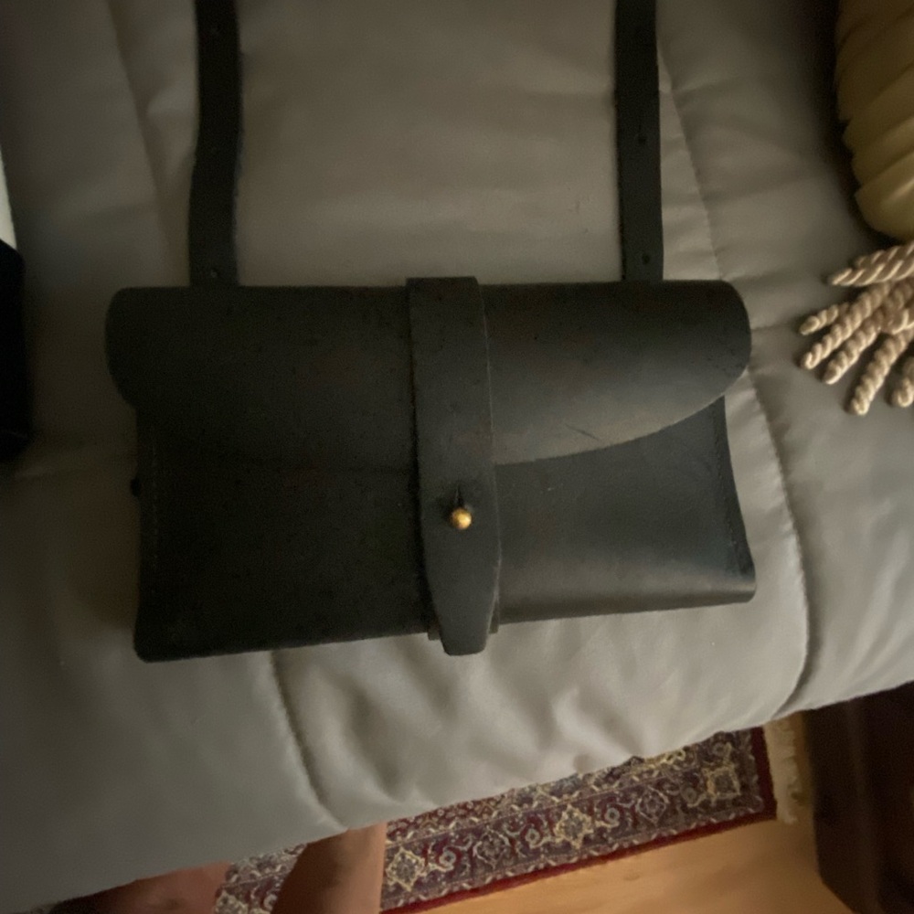 Crossbody, barely used. Fits credit cards and cellphone.